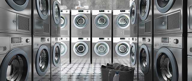 Row of washing machines with laundry in a basket, 3d render