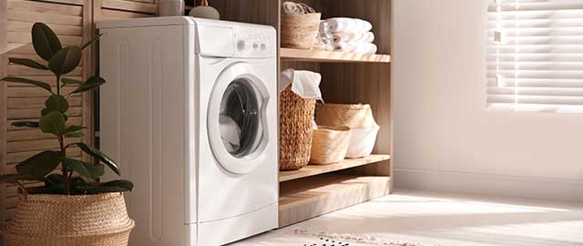 Modern washing machine and shelving unit in laundry